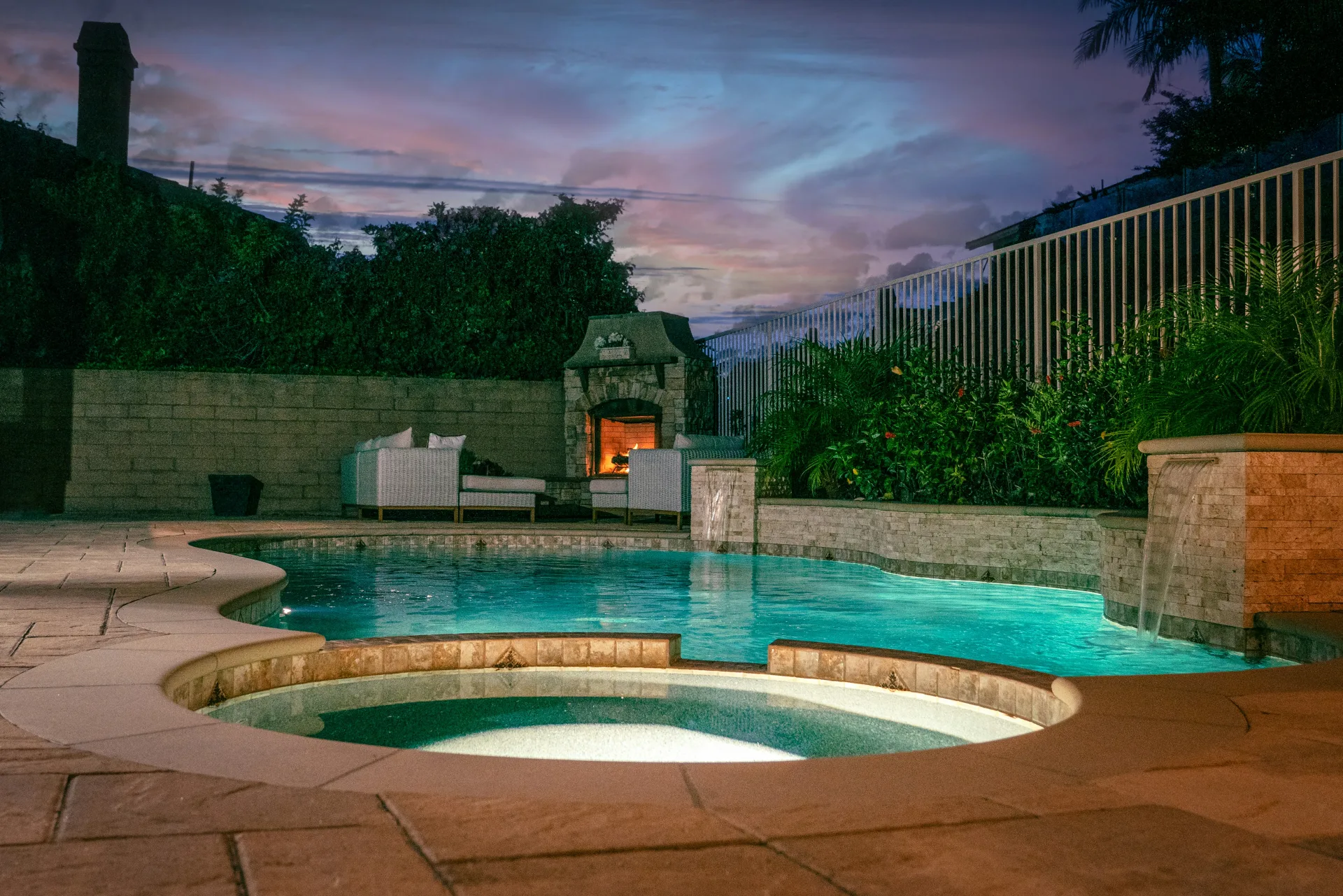 Twilight light reflecting off premium tile and spa edge